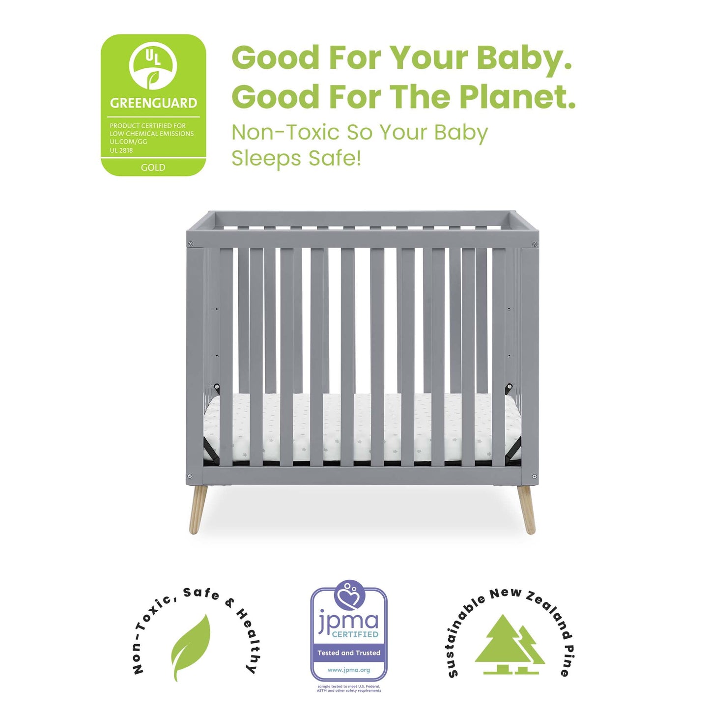 A grey baby crib with a mattress is displayed, surrounded by various certification logos and text