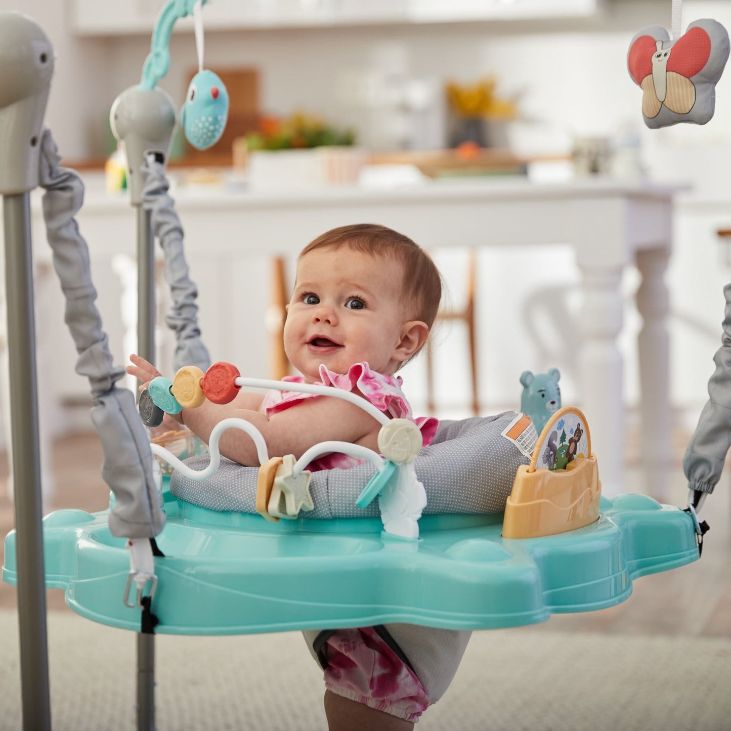 Image displaying a baby in a baby activity jumper