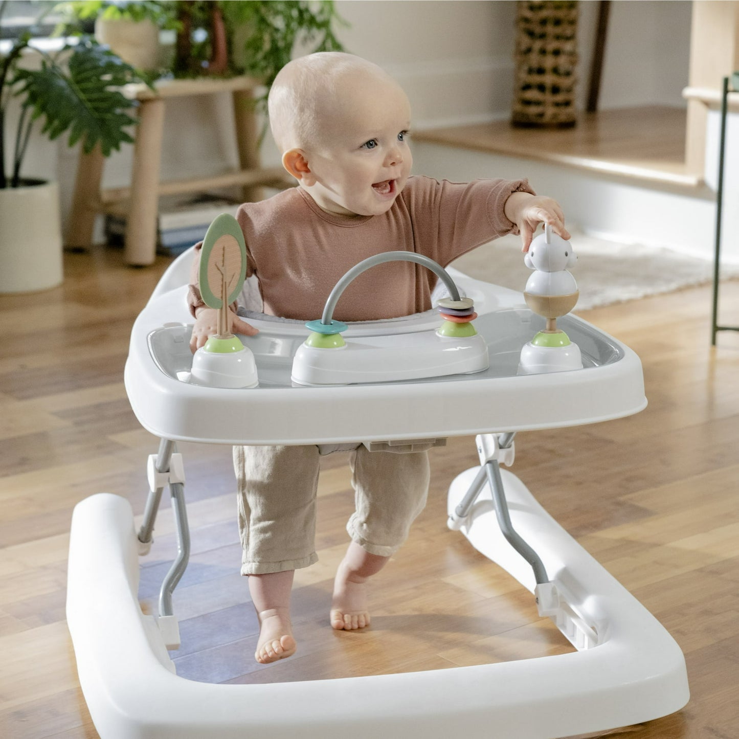 Image displaying a baby playing with a baby activity walker
