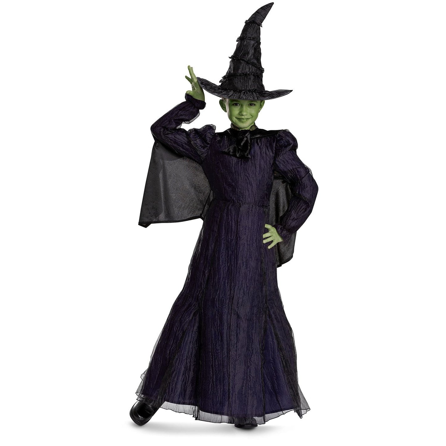 Child wearing a witch Halloween costume with a black hat and green face paint on a white background