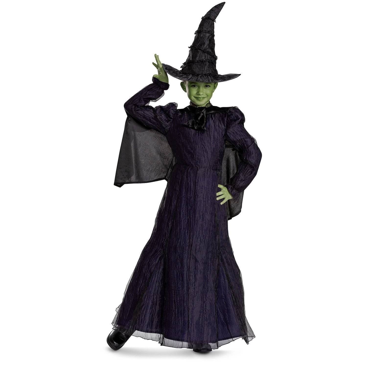 Child wearing a witch Halloween costume with a black hat and green face paint on a white background