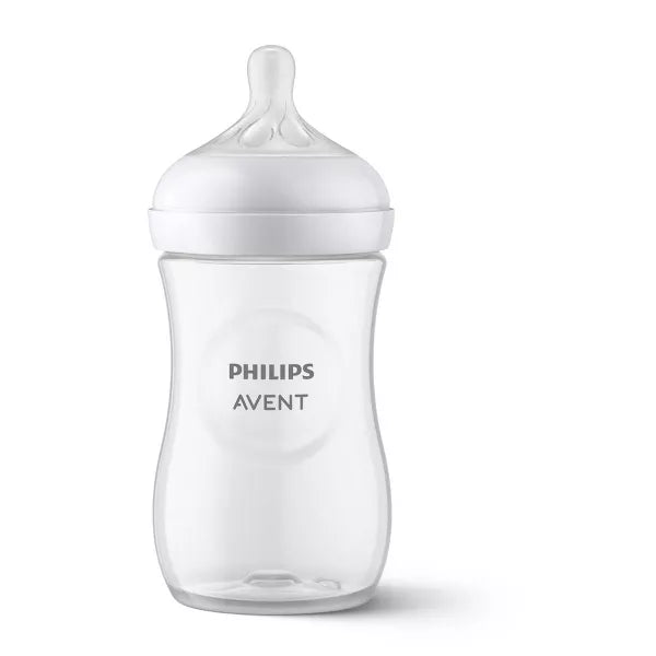 Clear baby bottle with white cap on a white background.