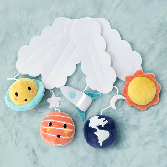 A baby crib mobile featuring plush planets, a rocket, moon, and star hanging below white cloud shapes