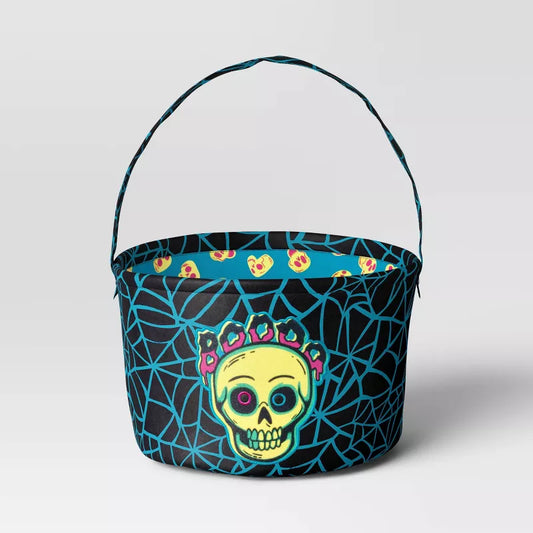 Halloween-themed candy bucket with skull design on a light gray background