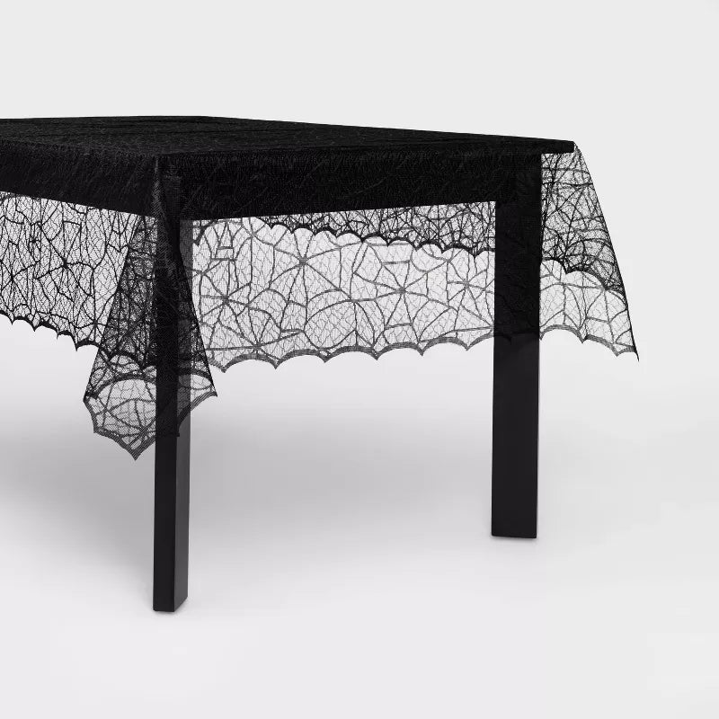 Halloween Black lace tablecloth with spider web design on a white background