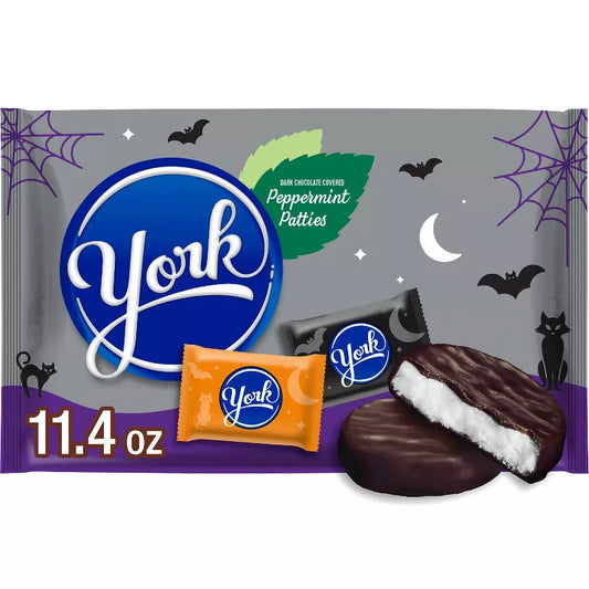 Halloween Themed Candy, Peppermint Patties Halloween packaging with cookies and candy bars on a gray background.