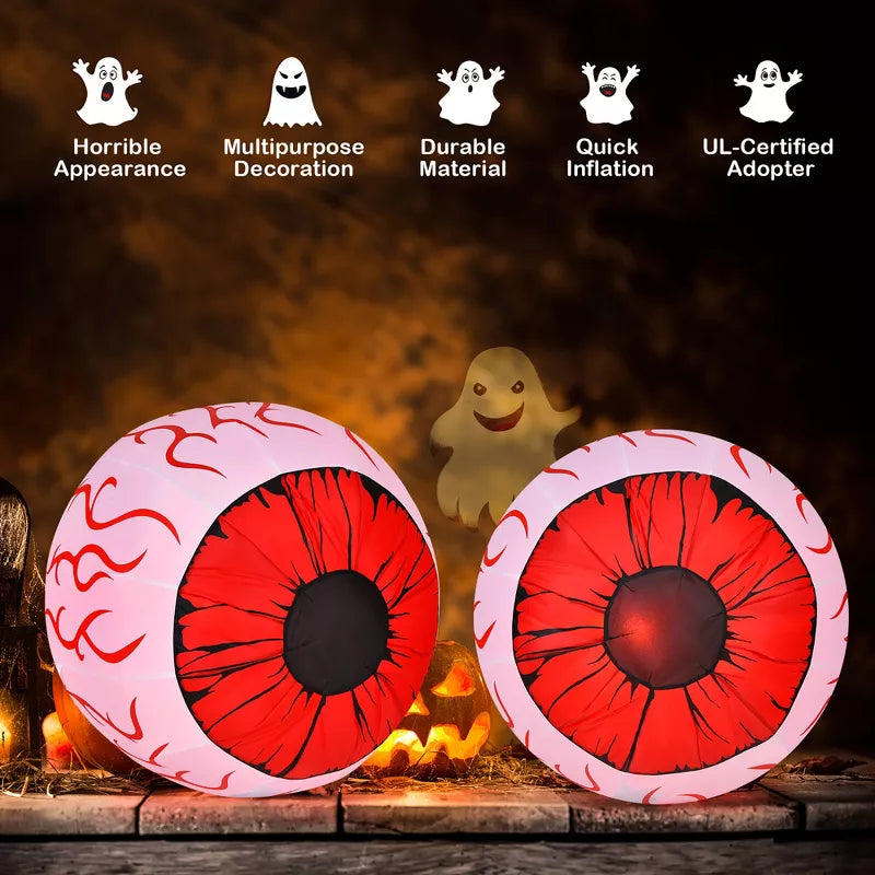 Halloween Themed, Two inflatable eye-shaped decorations with red and black design on a Halloween-themed background.