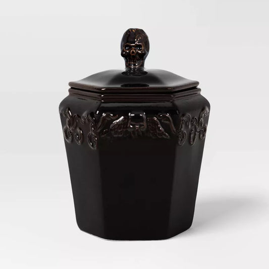 Halloween themed Black decorative jar with skull lid on a white background