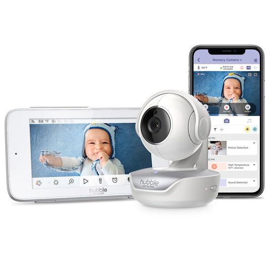 A baby monitor camera and its corresponding parent unit displaying a baby, alongside a smartphone app