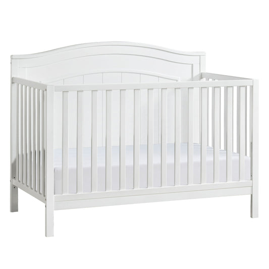 A white wooden baby crib with slatted sides and a curved headboard, containing a white mattress