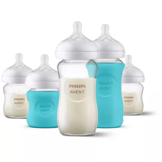 Set of baby bottles with blue and white designs on a white background