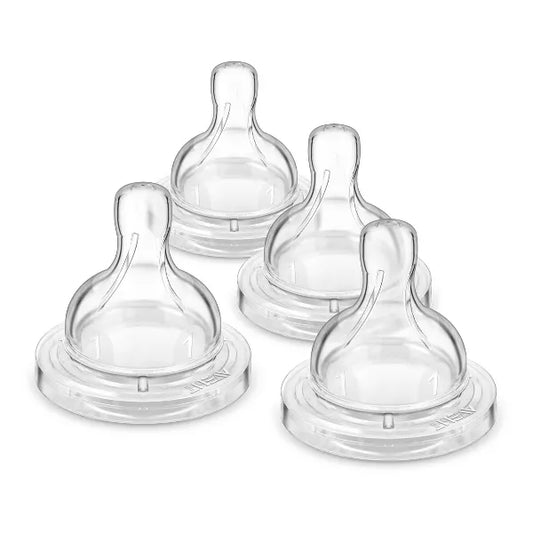 Set of clear baby bottle nipples on a white background