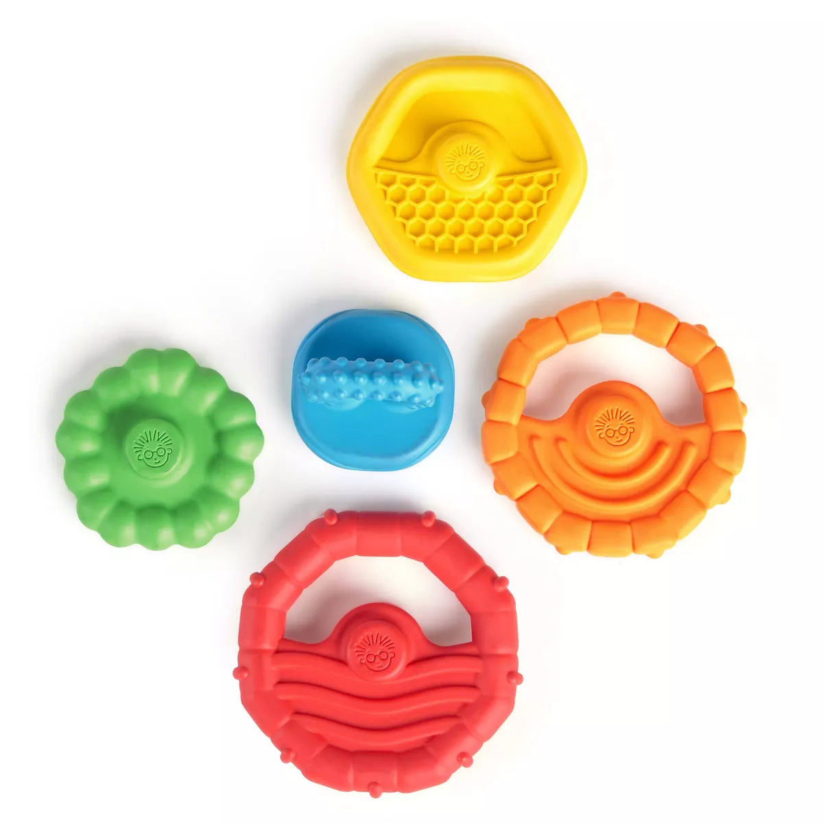Set of colorful silicone teething rings on a white background