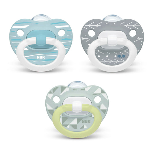 Three pacifiers with different designs on a white background