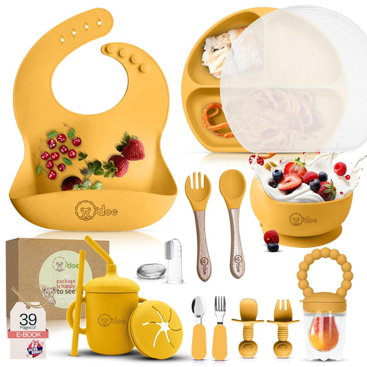 Yellow baby feeding set with bib, bowl, spoon, and other accessories on a white background