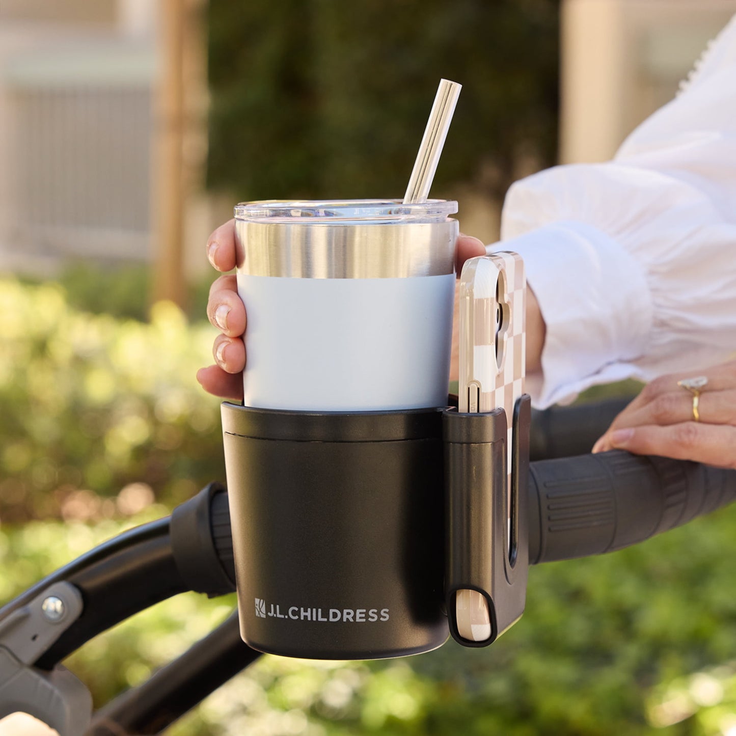 Image displaying a baby stroller accessory holding a cup and a mobile