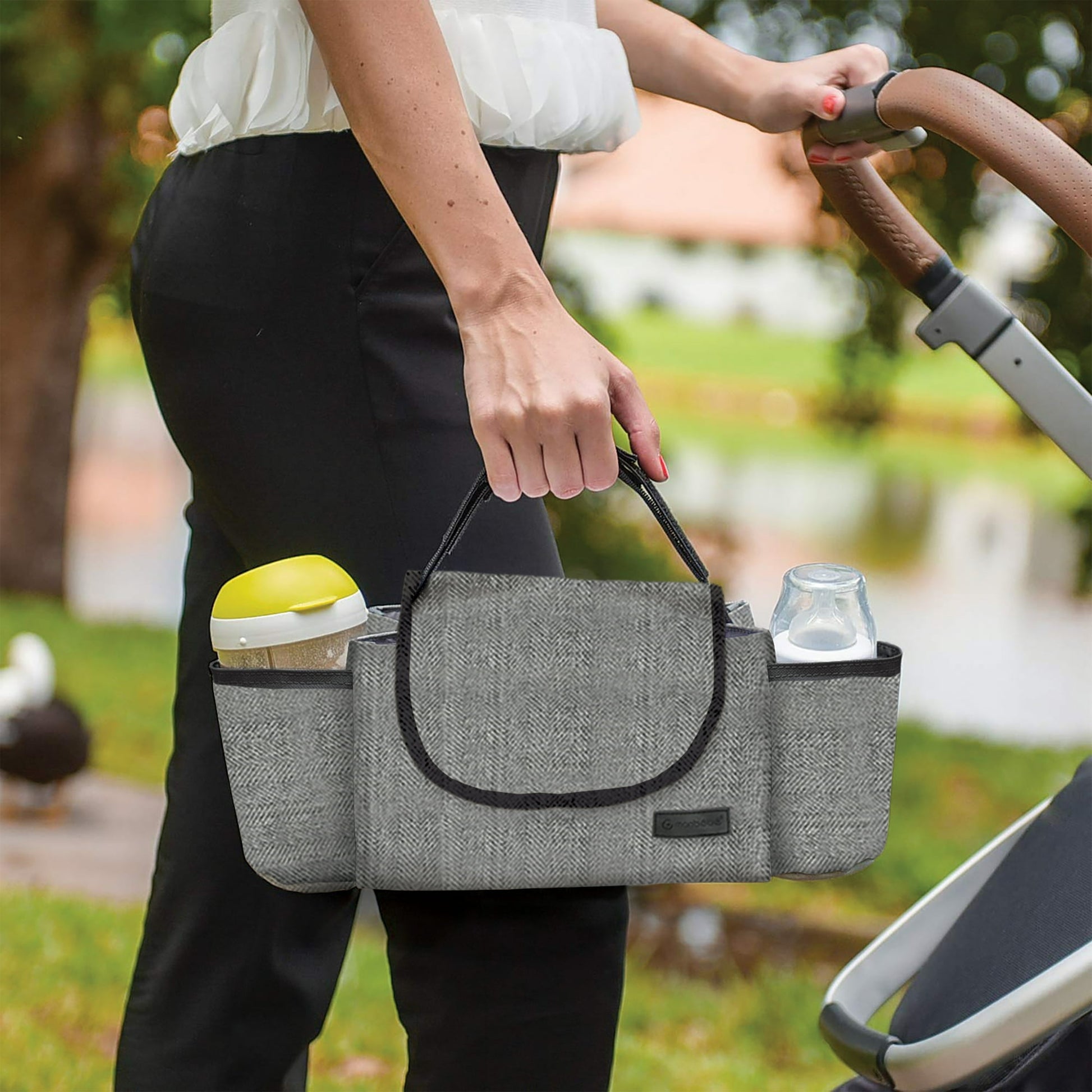 Image displaying a woman holding a baby stoller accessory
