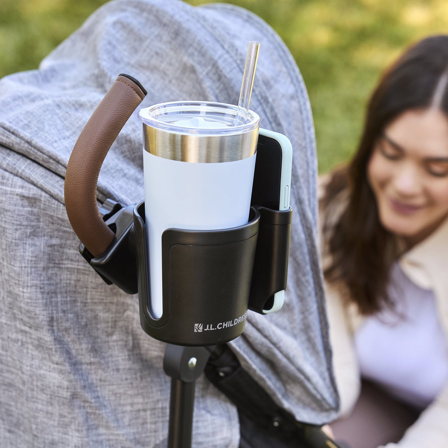 Image displaying a baby stroller accessory holding a cup and a mobile