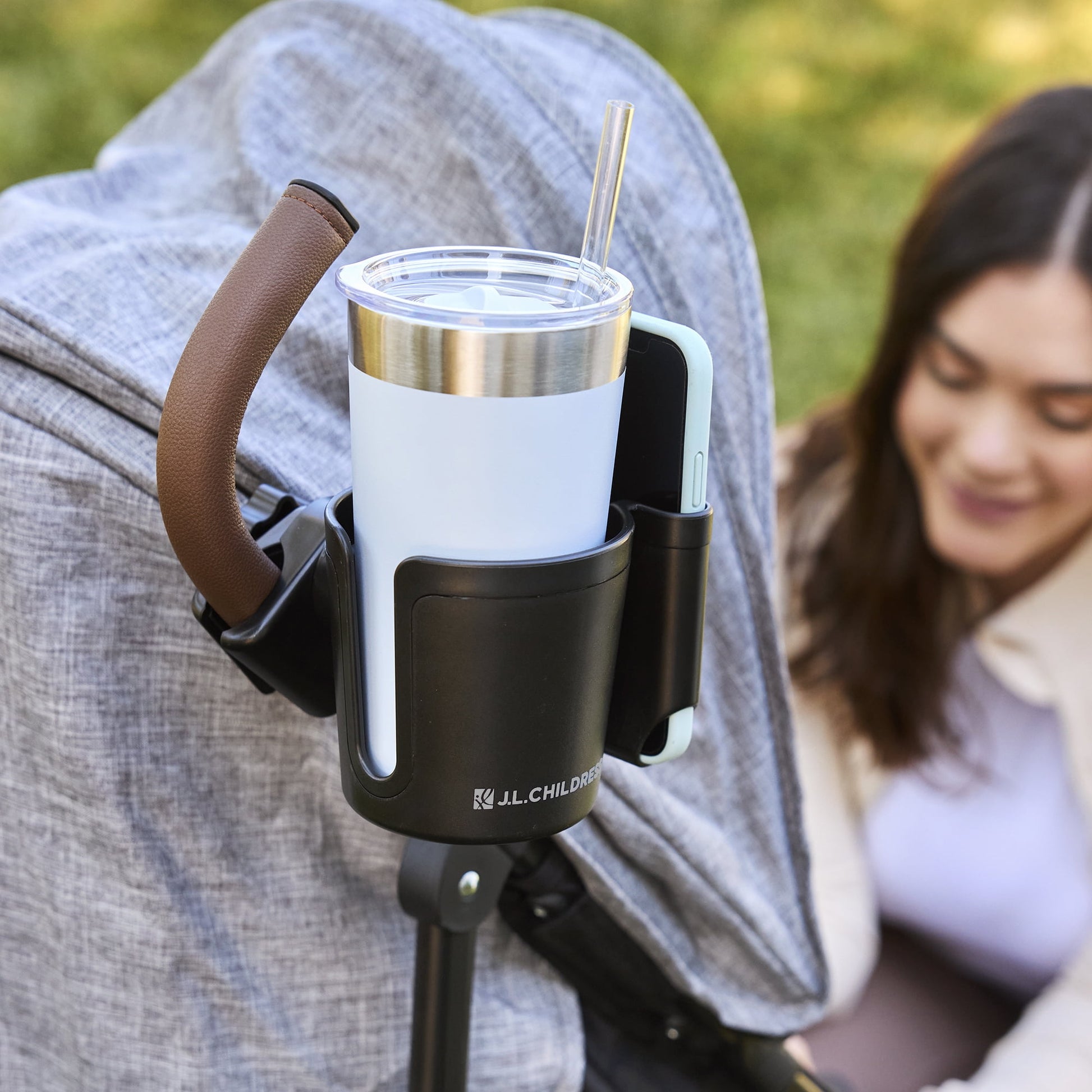 Image displaying a baby stroller accessory holding a cup and a mobile