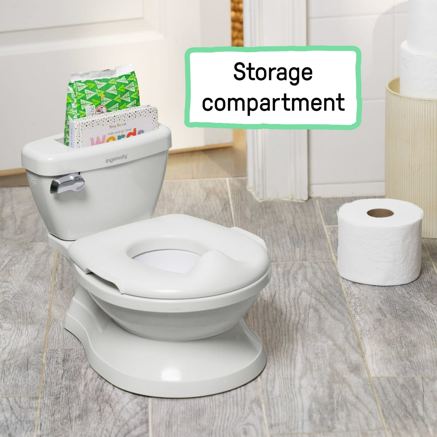 A white toddler potty training toilet with a storage compartment and toilet paper roll