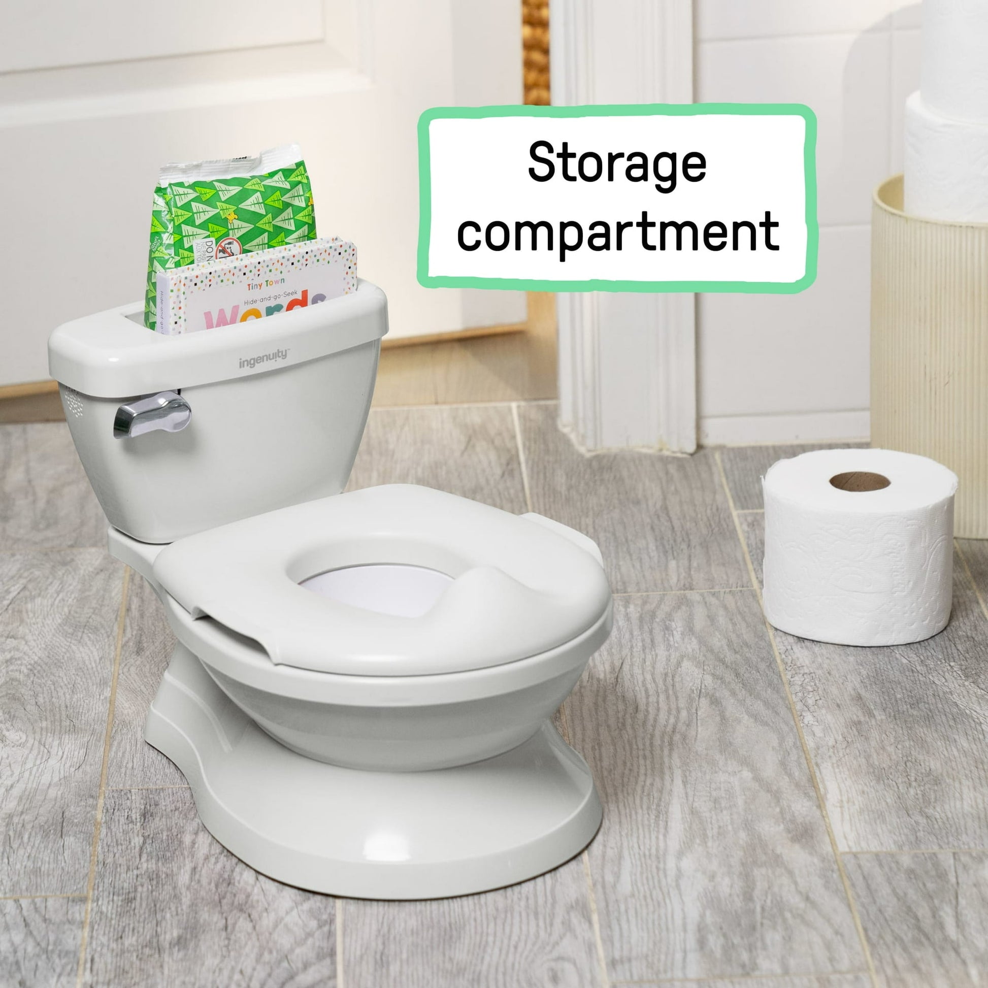 A white toddler potty training toilet with a storage compartment and toilet paper roll