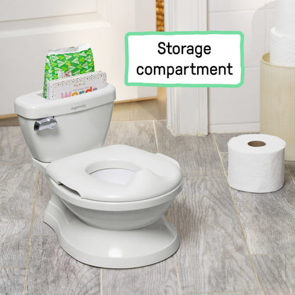 A white toddler potty training toilet with a storage compartment and toilet paper roll