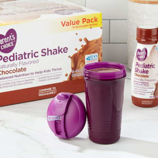 Box of pediatric shakes, bottle, and a cup filled with shake with a lid