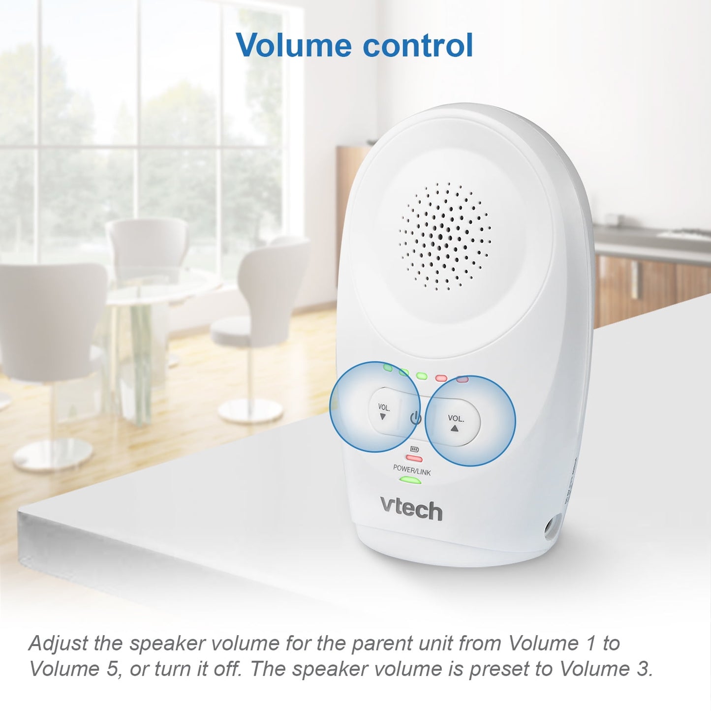 An audio baby monitor parent unit with visible volume controls on a white surface