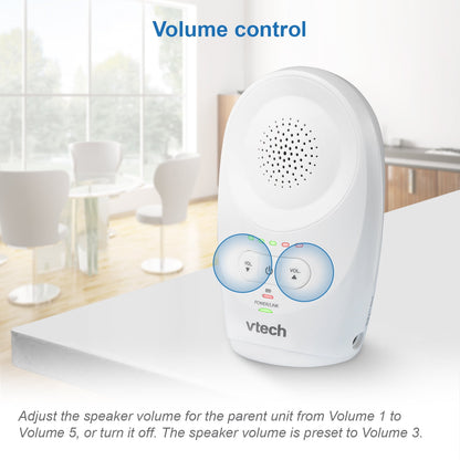 An audio baby monitor parent unit with visible volume controls on a white surface