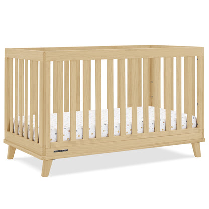 A wooden baby crib with slatted sides and a mattress, designed for infants.