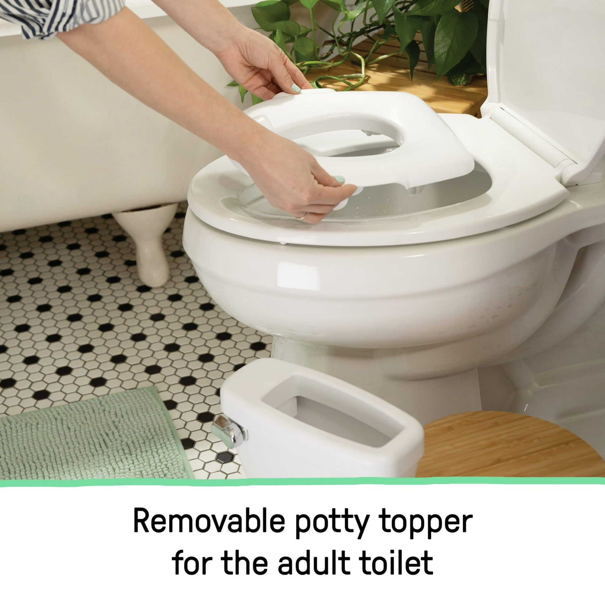 Hands placing a removable potty training seat onto an adult toilet