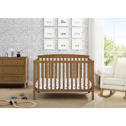 A nursery room with a wooden baby crib, a matching dresser, and a white rocking chair