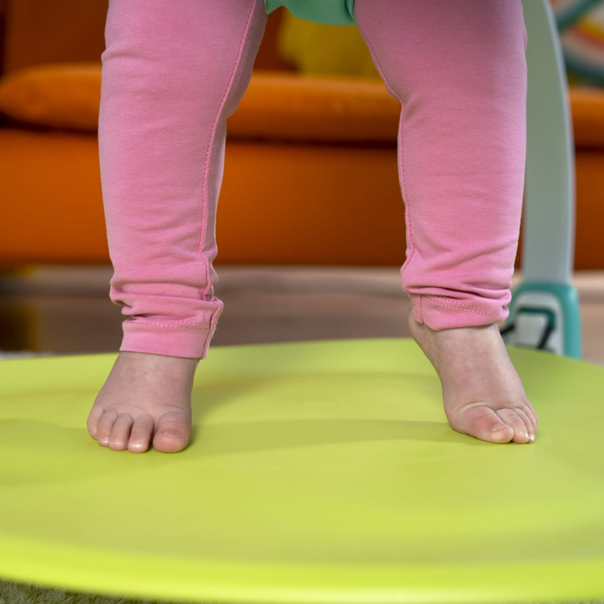 Image displaying a baby in a baby activity jumper