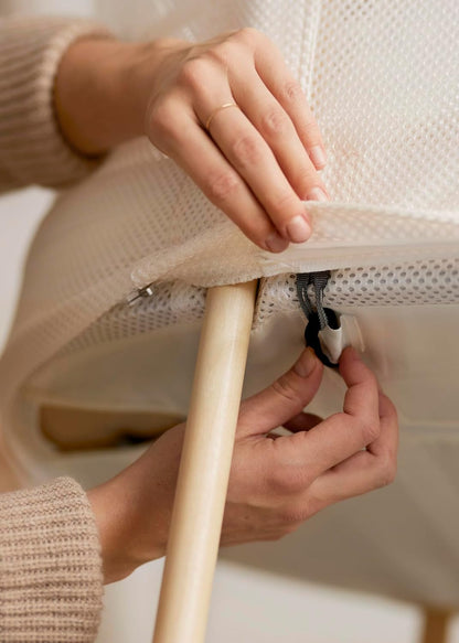 Image displaying hands and a baby bassinet