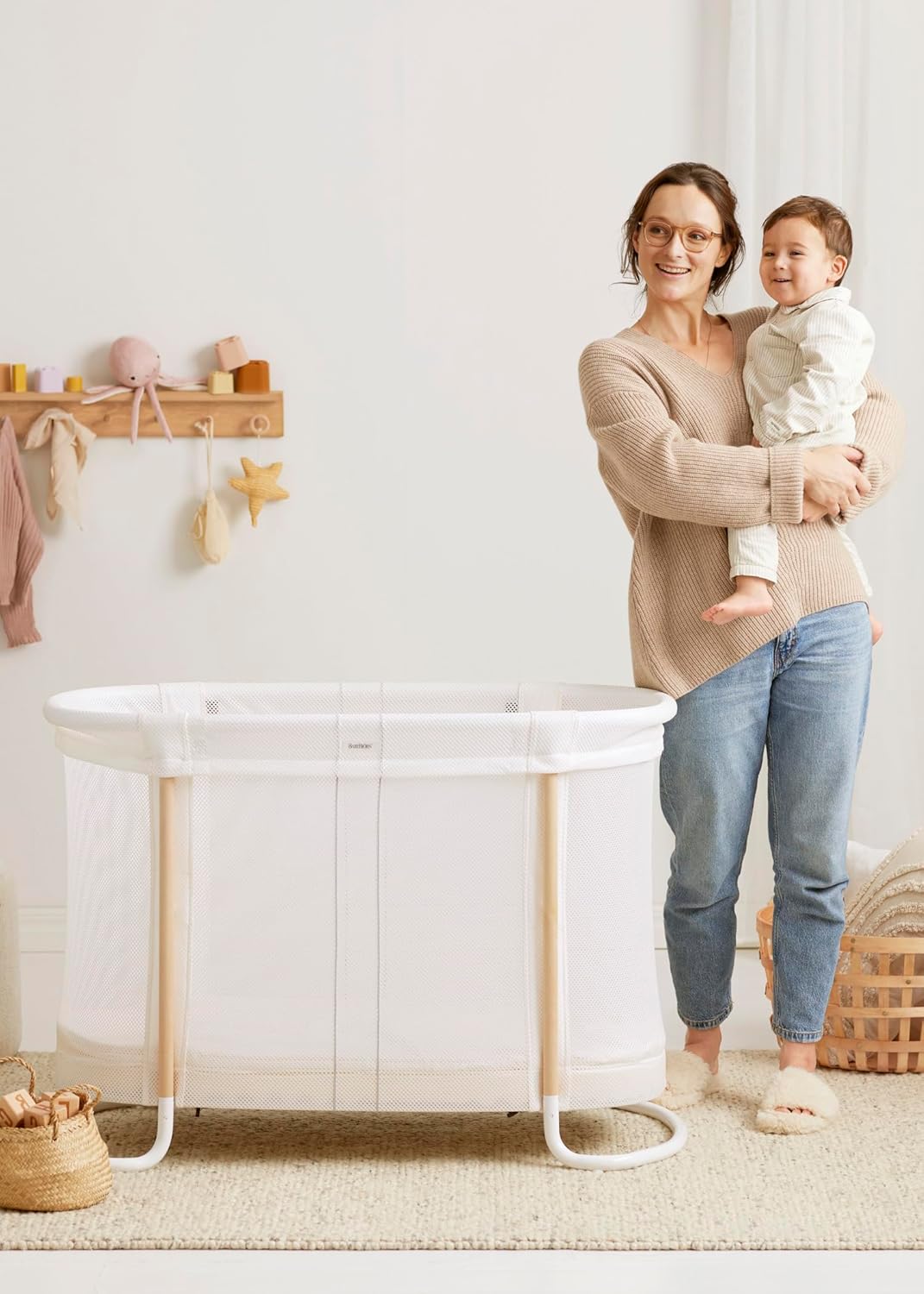 Image displaying a baby bassinet and a women with a baby