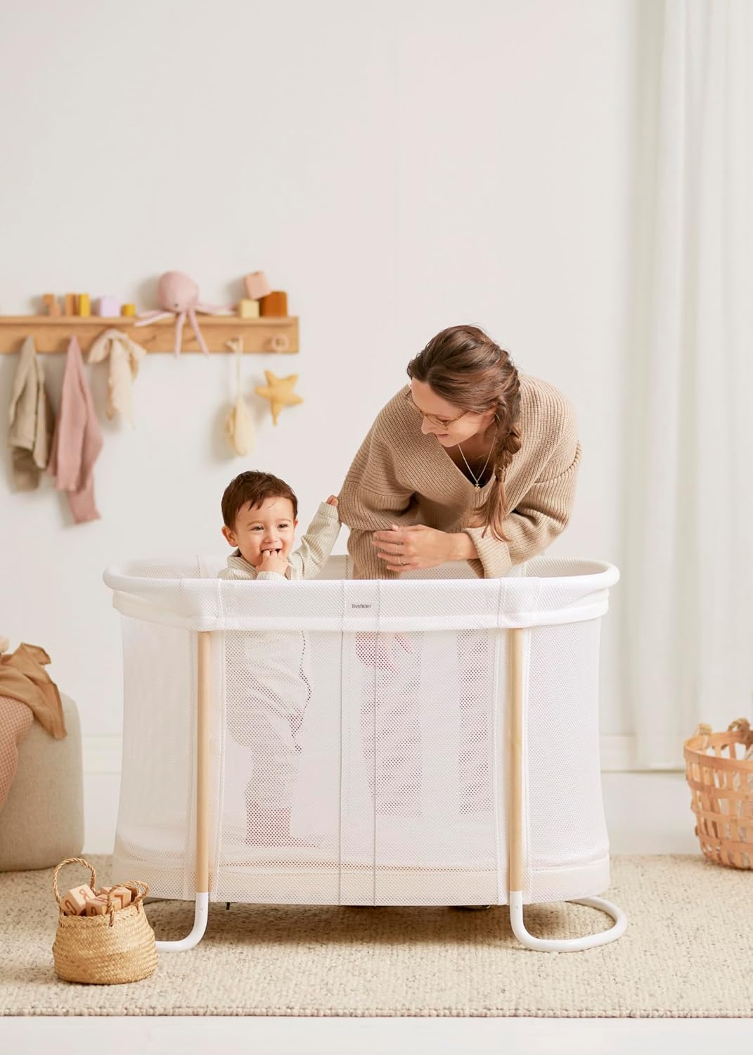 Image displaying a baby bassinet and a women with a baby