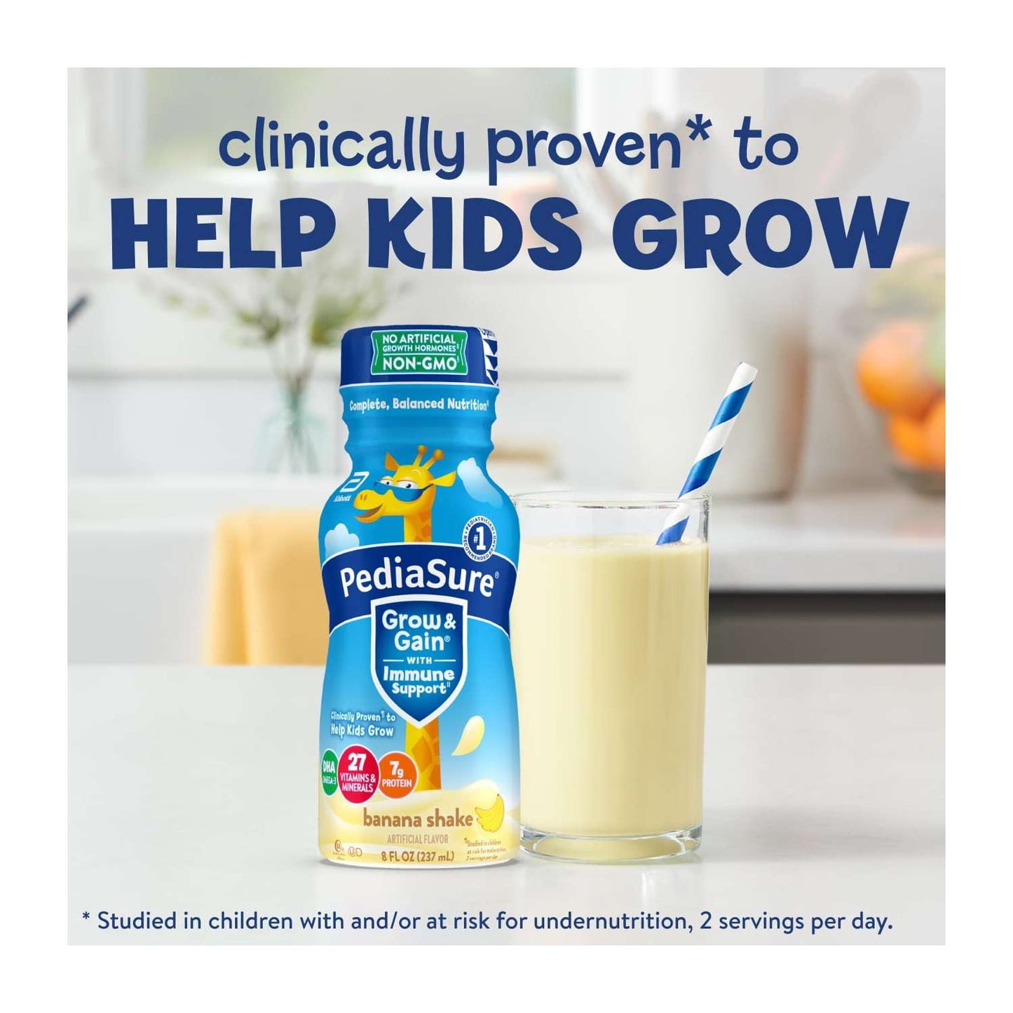 A bottle and a glass of nutritional shake with a straw on a counter, with blue text