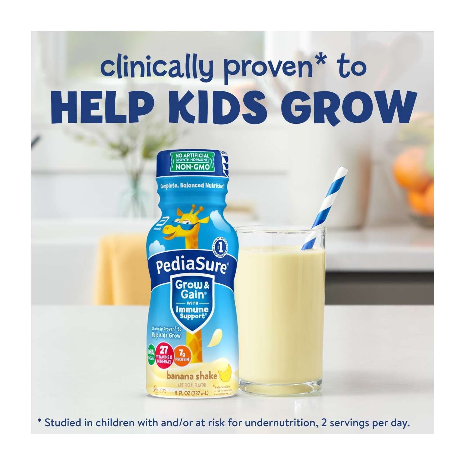 A bottle and a glass of nutritional shake with a straw on a counter, with blue text