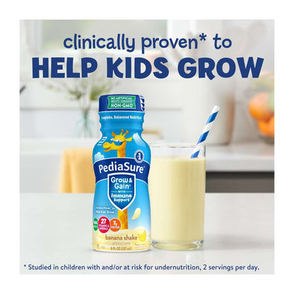 A bottle and a glass of nutritional shake with a straw on a counter, with blue text