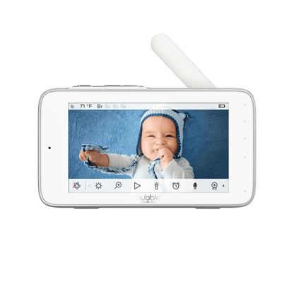 A white baby monitor displaying a baby on screen, with control icons below the display