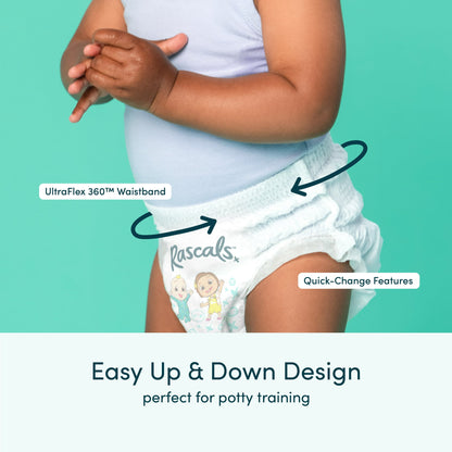 A baby wears a light-colored training pant with cartoon characters, shown from the waist down on a teal background