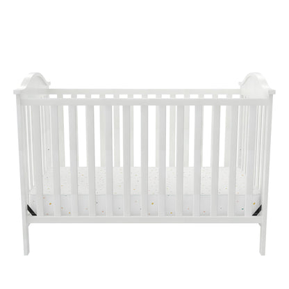 A white baby crib with a mattress, designed for infants and toddlers