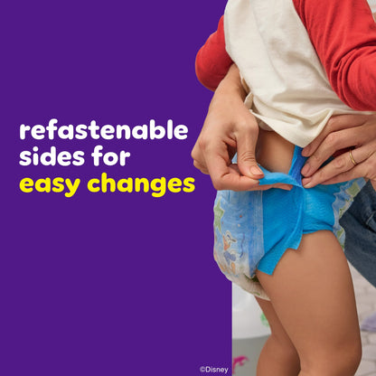 An adult adjusting a child's training pants with refastenable sides