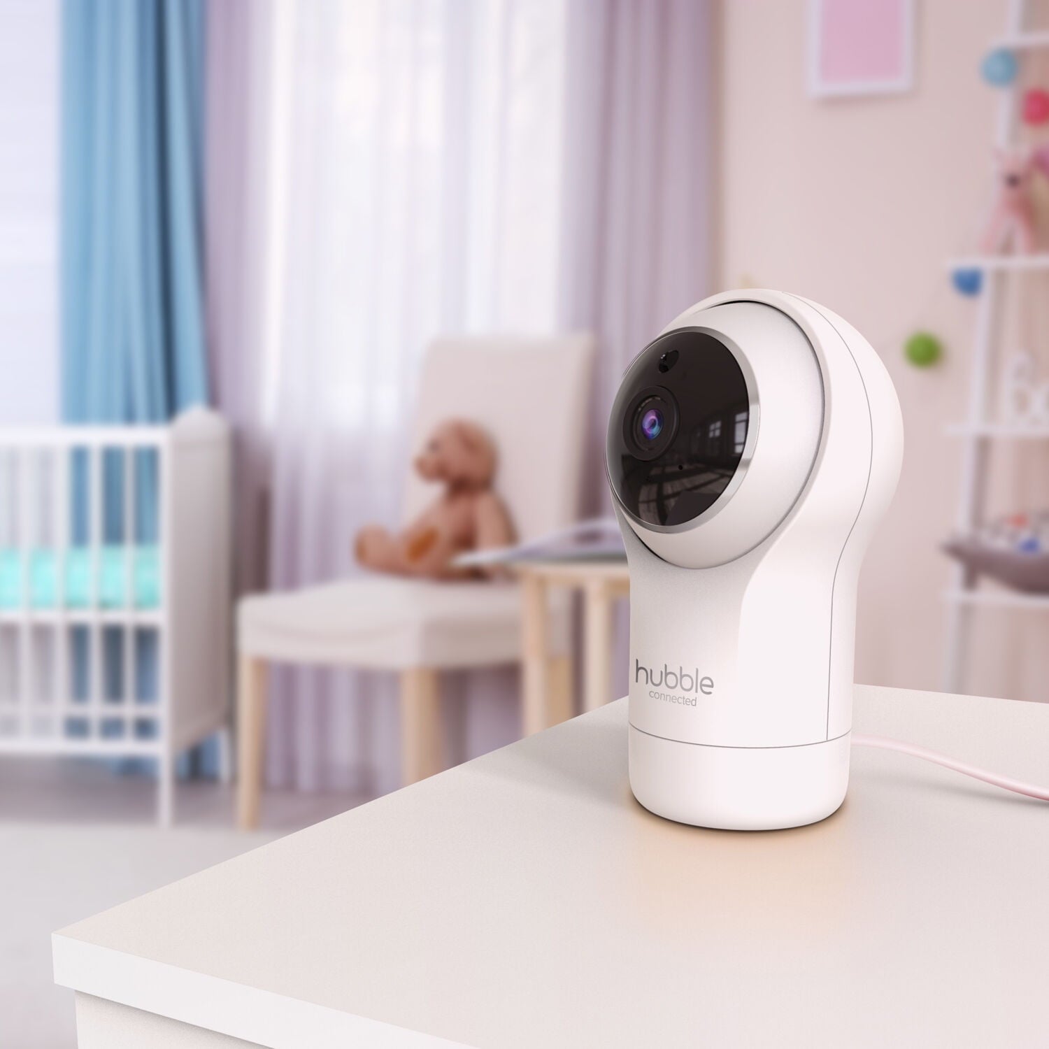 A white baby monitor camera on a table in a child's nursery room