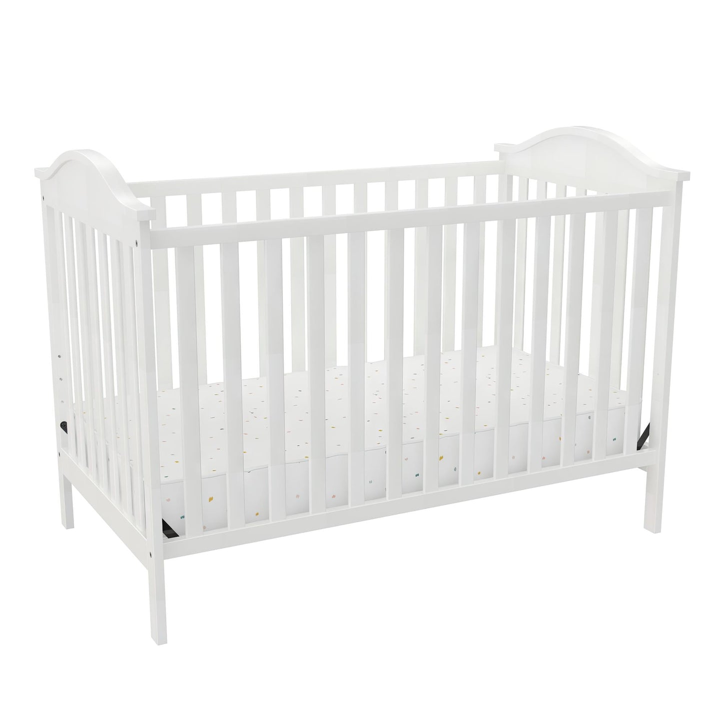 A white wooden baby crib with a patterned mattress in a brightly lit setting