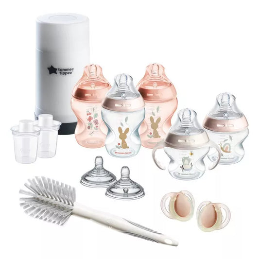 Baby bottle set with accessories on a white background.