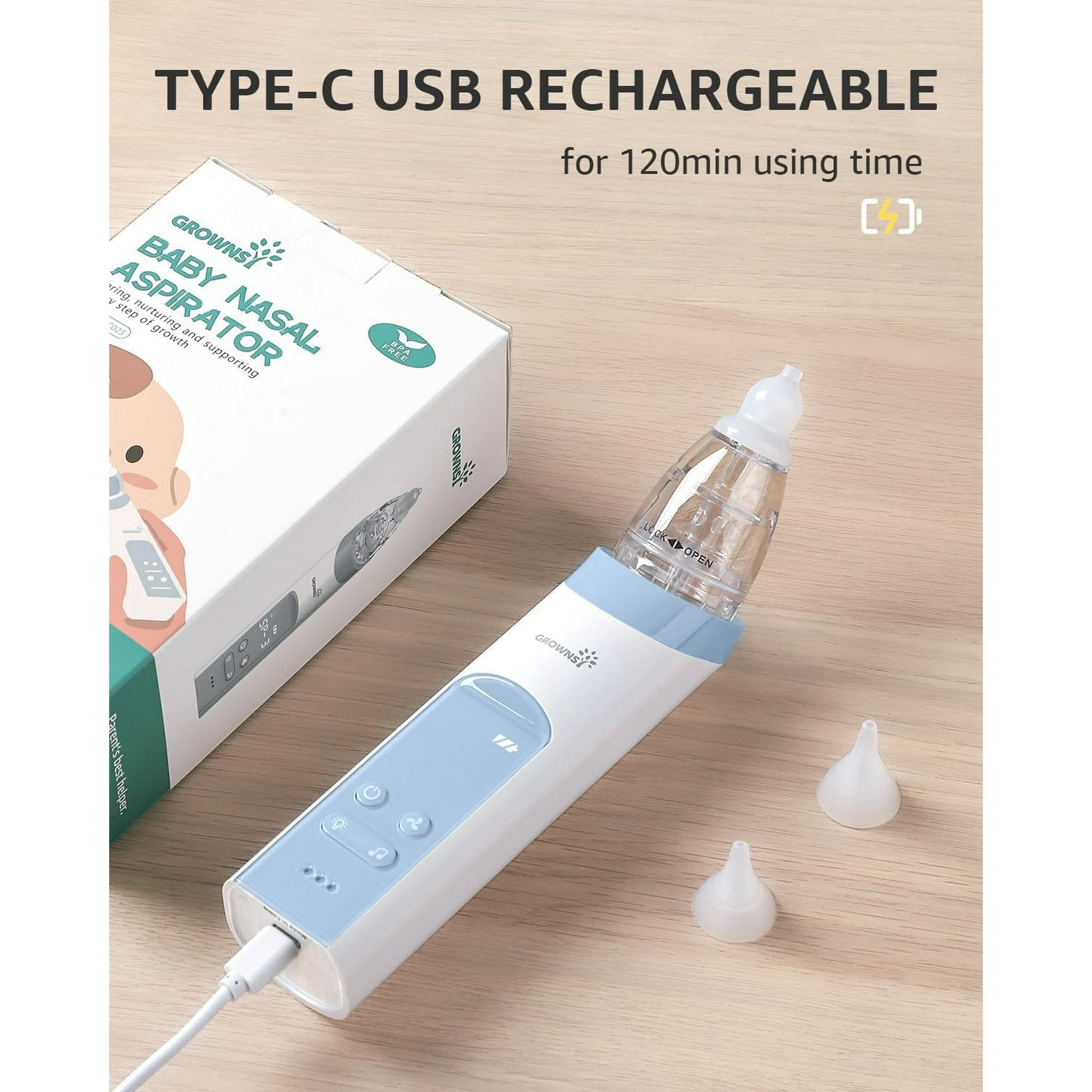 Baby nasal aspirator with USB cable and packaging on a wooden surface