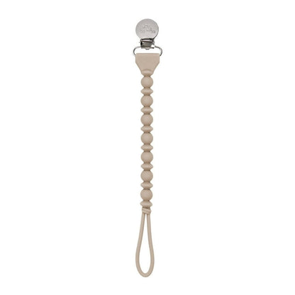 Beige pacifier clip with a beaded design on a white background