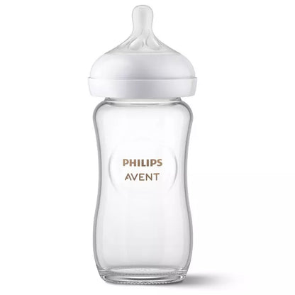 Clear baby bottle with white cap on a white background.
