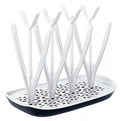 Compact baby bottle drying rack with vertical pegs for drying bottles, nipples, and pump parts – space-saving countertop solution for hygienic air-drying.
